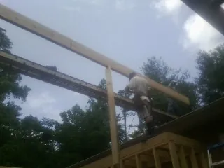 Carpenter setting a ridge beam over a new addition frame — Ice Dam Removal by Roofing Brothers in French Lick