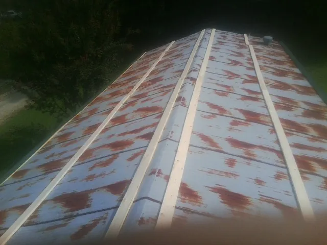 Rusted metal roof panels with new wood purlins before replacement — Storm Damage Roof Repair in French Lick by Roofing Brothers